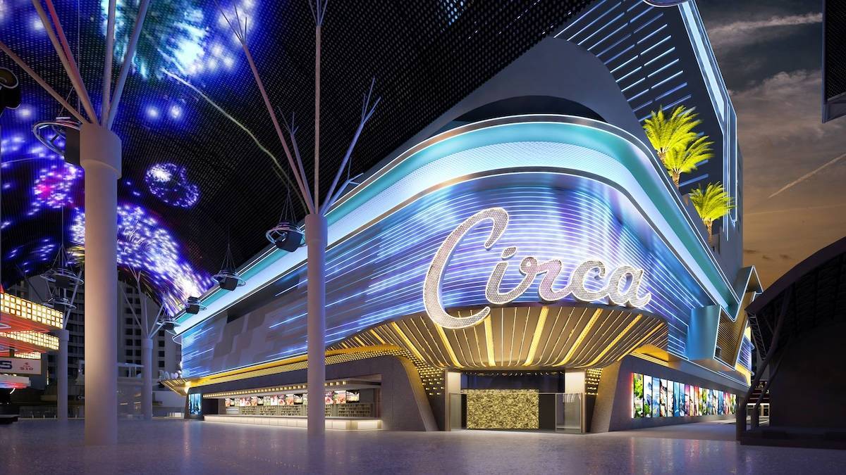 Exterior of a hotel at a corner of Fremont street under a canopy of digital fireworks